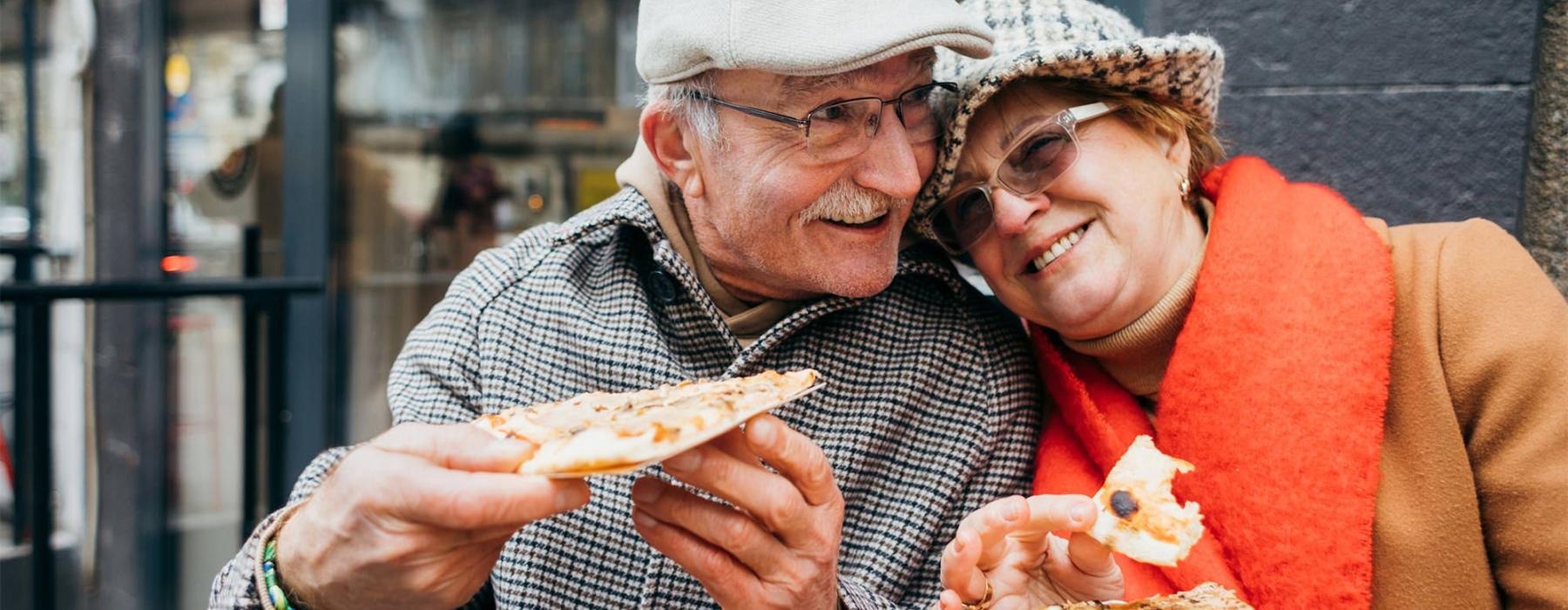 a couple eating pizza